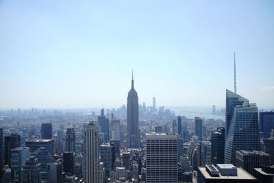 Modern buildings in city against clear sky