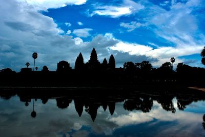 Reflection of silhouette buildings in lake