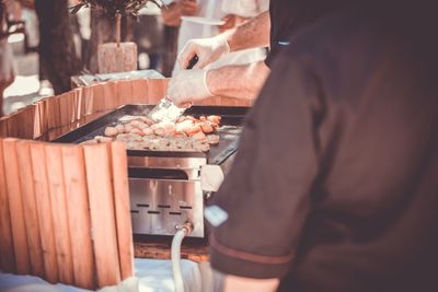 Midsection of man preparing food