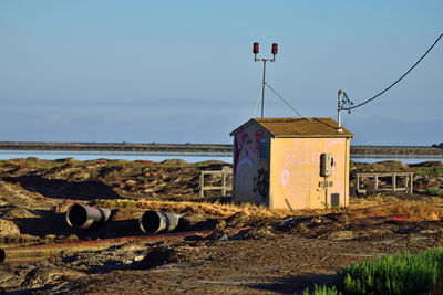 Built structure on beach against sky