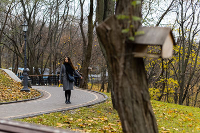 Rear view of woman standing by plants