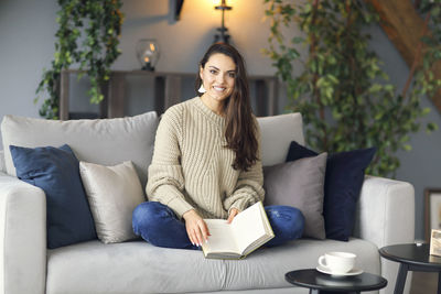 Man sitting on sofa at home