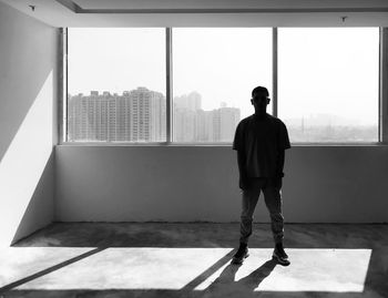 Rear view of man standing on wall