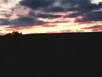 Silhouette landscape against sunset sky