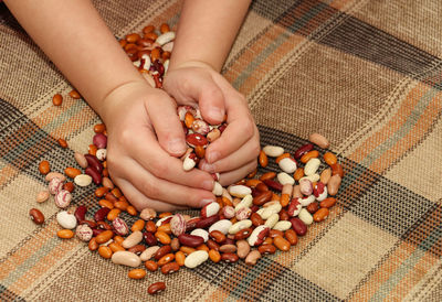 Cropped image of girl hand holding kidney bean