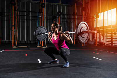 Low section of woman exercising in gym