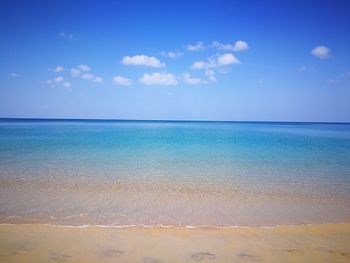 Scenic view of sea against blue sky