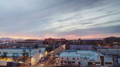 High angle view of illuminated buildings against sky at sunset