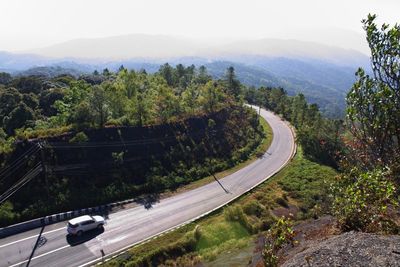 High angle view of road amidst trees and mountains