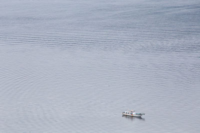High angle view of boat sailing in calm sea