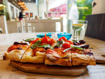 Close-up of pizza served on table
