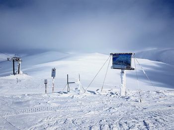 Snow covered field against sky