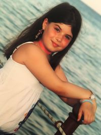 Portrait of smiling girl sitting outdoors