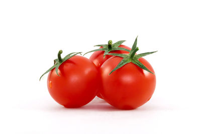 Close-up of tomatoes against white background