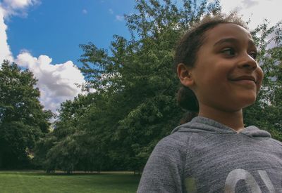 Close-up of boy in park against sky