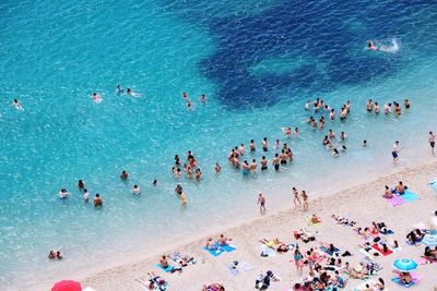 High angle view of people swimming in sea