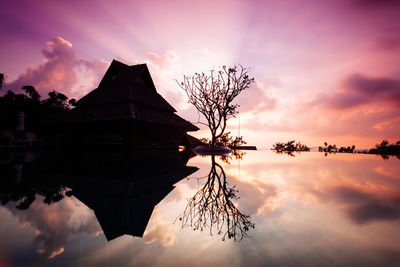 Silhouette built structure against sky during sunset