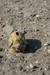 High angle view of a piggy bank on sand