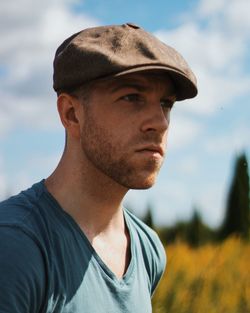 Close-up of handsome man against sky