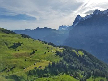 Scenic view of green mountains against sky