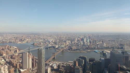 High angle view of cityscape with bridges and river against sky