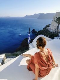 Rear view of woman looking at sea against sky