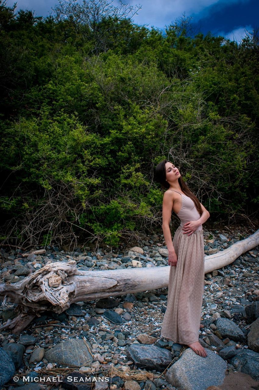 young adult, lifestyles, casual clothing, standing, person, leisure activity, tree, young women, full length, sitting, sunlight, relaxation, three quarter length, day, plant, nature, outdoors, looking away