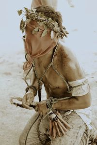 Close-up of horse on sand at beach against sky