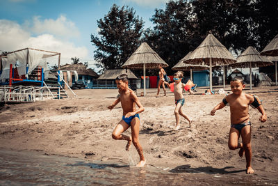 People on beach against sky