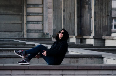 Portrait of young woman sitting outdoors