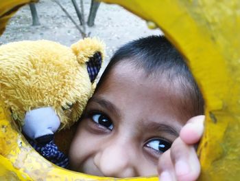 Portrait of playful boy seen through play equipment