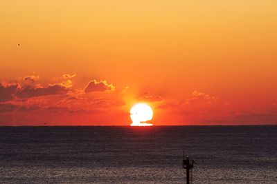 Scenic view of sea against orange sky