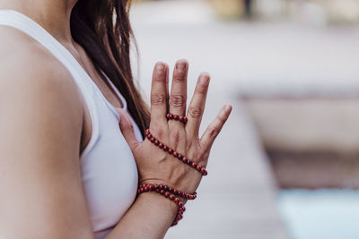 Midsection of woman with hands clasped