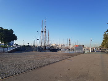 Sailboats on road against clear blue sky