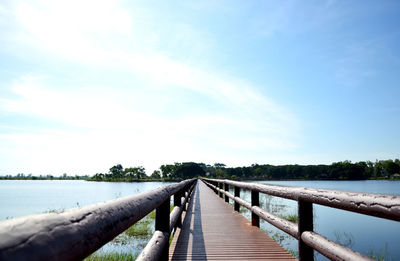 Pier over lake against sky