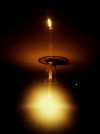 Close-up of illuminated light bulb in the dark