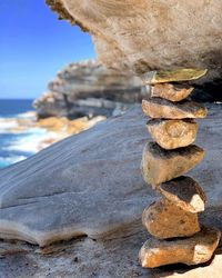 Stack of rocks on beach against sky