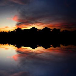 Scenic view of lake against orange sky