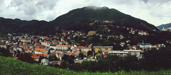 Town by mountains against sky