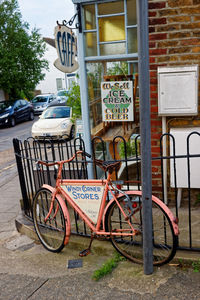 Bicycle parked on sidewalk in city