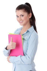 Portrait of a smiling young woman against white background