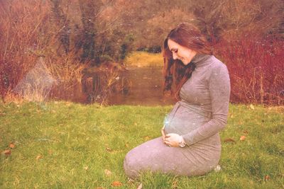 Side view of woman wearing sunglasses on field