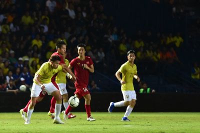 Group of people playing soccer on field