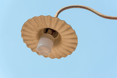 Low angle view of light bulb against clear blue sky