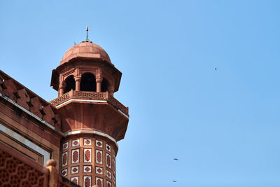 Low angle view of building against clear blue sky