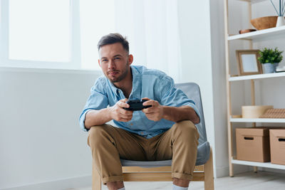 Portrait of man playing video game