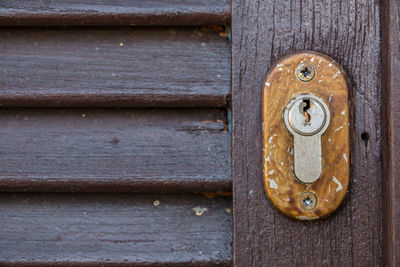 Full frame shot of old wooden door with keyhole