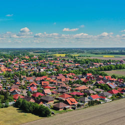 Aerial view of a new housing estate with detached houses at the edge of a village