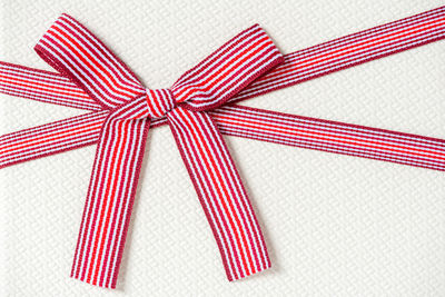 Close-up of red ribbon tied on gift box