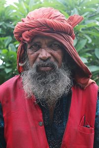 Portrait of man with red umbrella